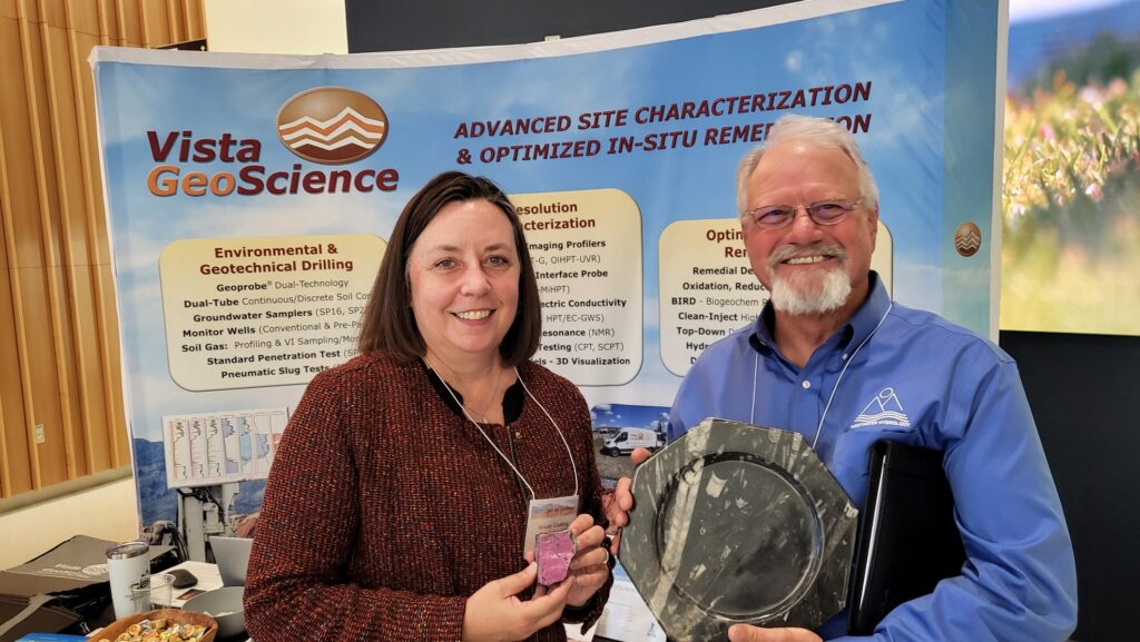 Vista GeoScience raffle winner holding their prize at an industry conference
